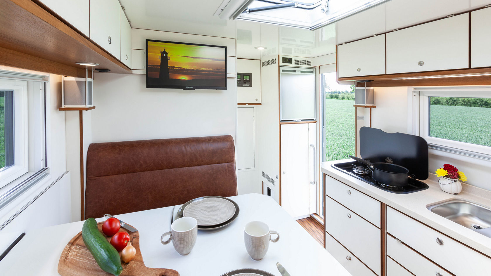 Interior of a motorhome with a set table.