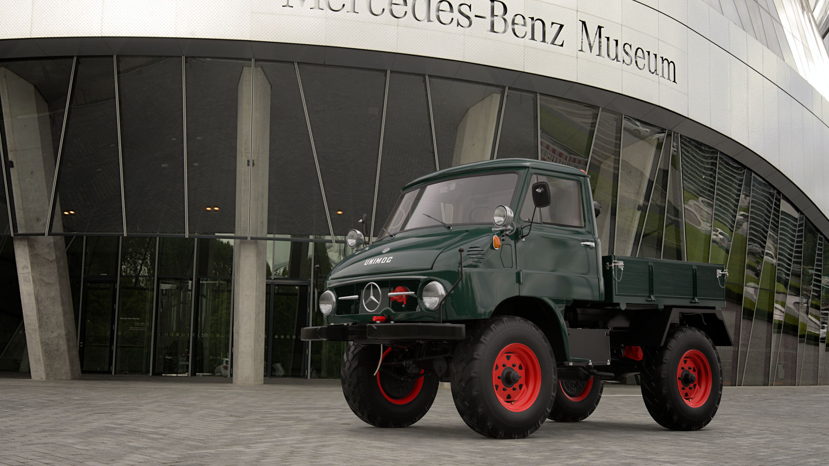 Een groene Mercedes-Benz Unimog met rode wielen staat voor het Mercedes-Benz Museum. De vrachtwagen toont een robuust ontwerp, ideaal voor offroad-toepassingen.