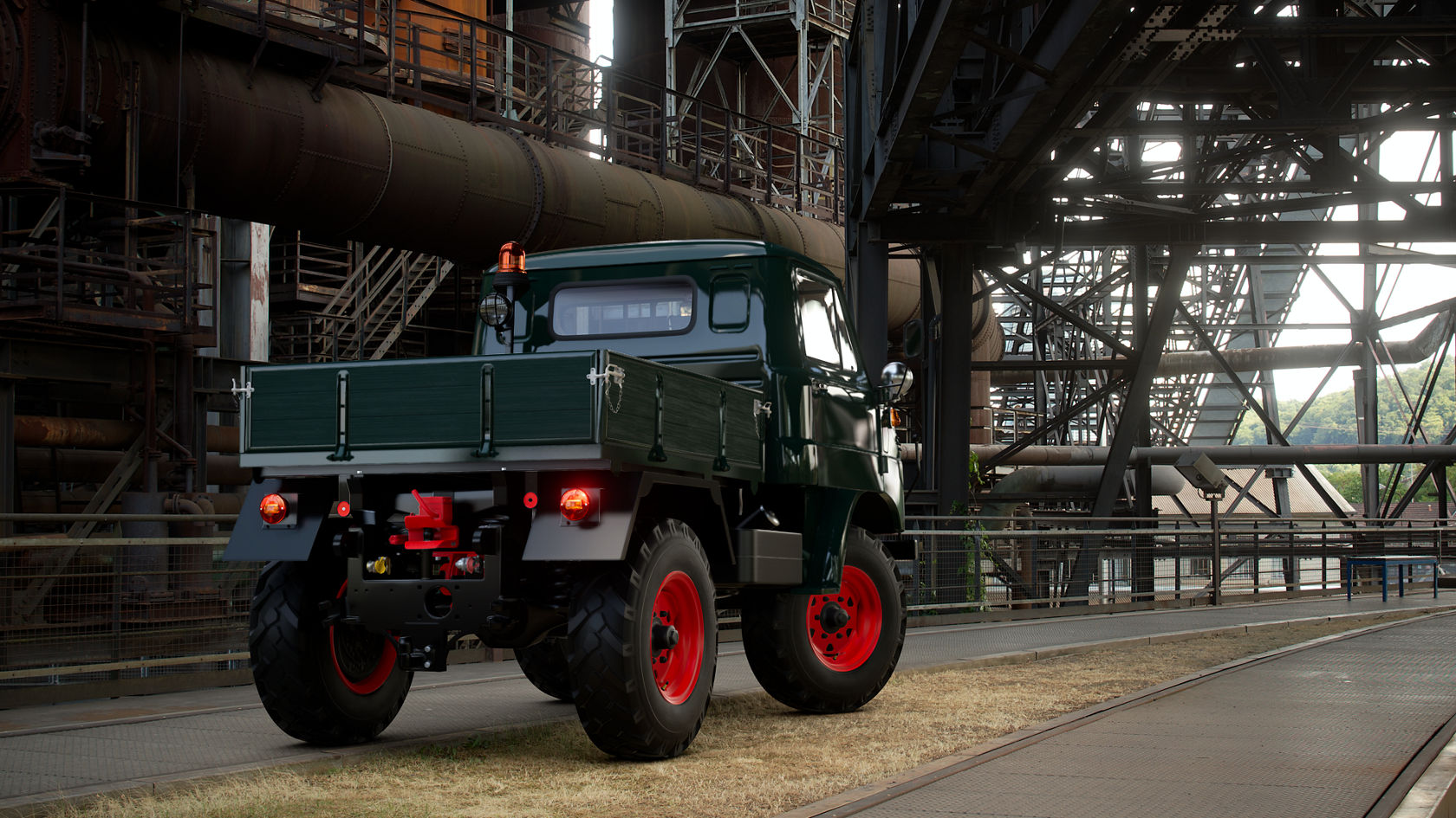 Een Mercedes-Benz Unimog staat op een industrieel terrein, met een zichtbare opbouw en felrode banden, omgeven door grote staalconstructies en buizen.